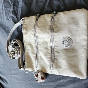 Well loved Kipling gray crossbody purse with‎ gorilla charm